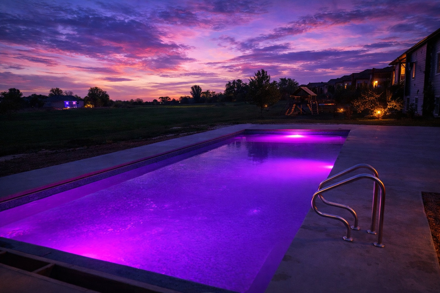 Custom pool with landscaped hillside at sunset — inground pool builder Iowa Nebraska